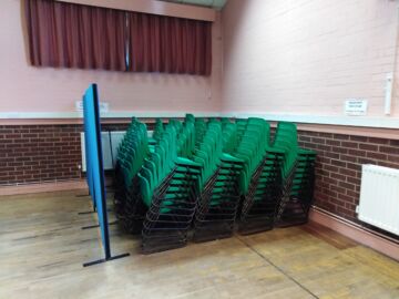 The main hall is equipped with tables and chairs