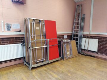 The main hall is equipped with tables and chairs